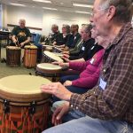 Photo of a drum circle by Rhythm for Unity at memory café .