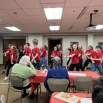 Photo of the Fort Atkinson High School Show Choir performing at a memory café.