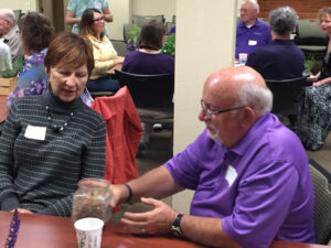 Two people sitting at a table at an event