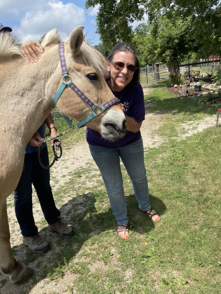 Angela poses with the horse Herger