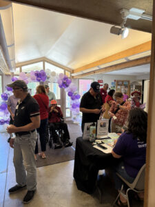 A group of Memory Cafe participants sign in for a fun event.