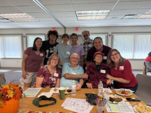 Group shot of the participants at a fall-themed Memory Cafe.