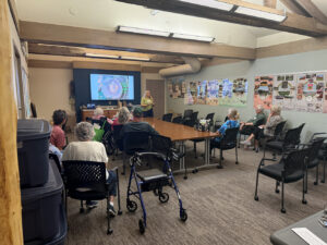 A woman gives a presentation on tree rings.