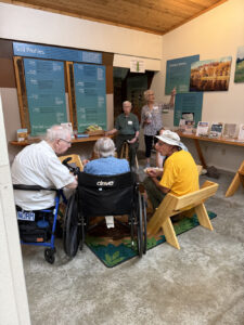 A small group of people at a museum exhibit on Soil Profiles.