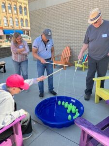 Three men go fishing in a kiddie pool.