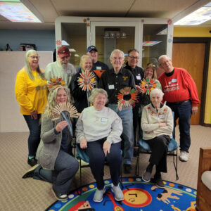 Group shot of Memory Cafe participants who made wreathes out of clothespins