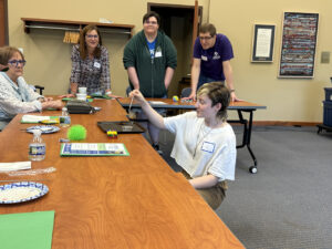A young person named Al presents on a couple butterflies on a tray