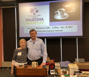 A woman poses with Gerard Iwinski for the Memory Cafe Coffee, Tea, & Me!