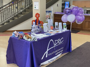 A display table for the Aging and Disability Resource Center of Jefferson County shows of piles of brochures and flyers for people to take.