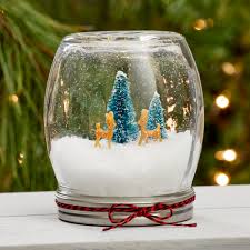 a homemade snowglobe made with an upside down jar
