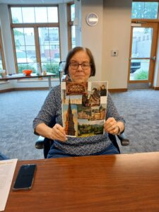 A participant proudly holding up their collage art.