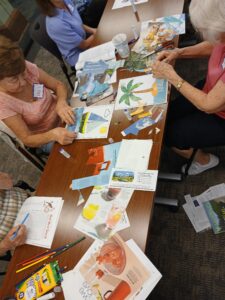 Participants work on collage art and word searches at a table.