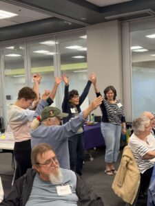 People stand while holding hands in a dance